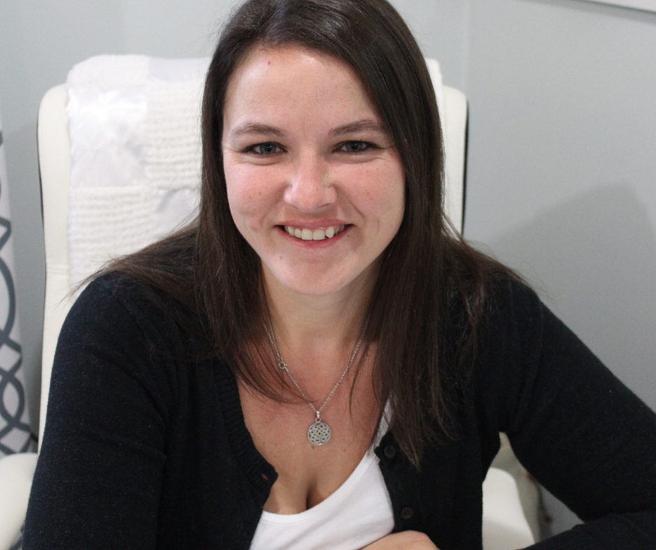 heather deveaux sitting at her desk wearing a black and white top in a white chair. Heather Deveaux Learning & Development