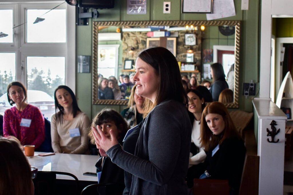 Heather Deveaux speaking in front of a group of women entrepreneurs. Heather Deveaux Learning & Development