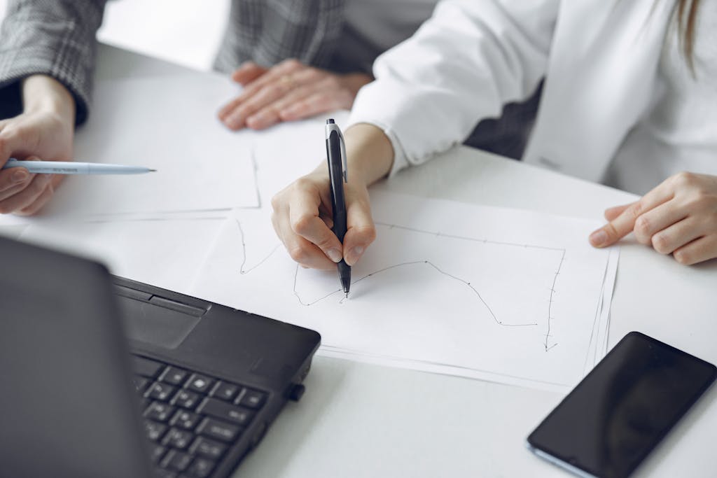 Close-up of professionals analyzing data and working together during a meeting.