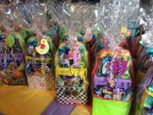 easter baskets lined up on a table with colorful paper