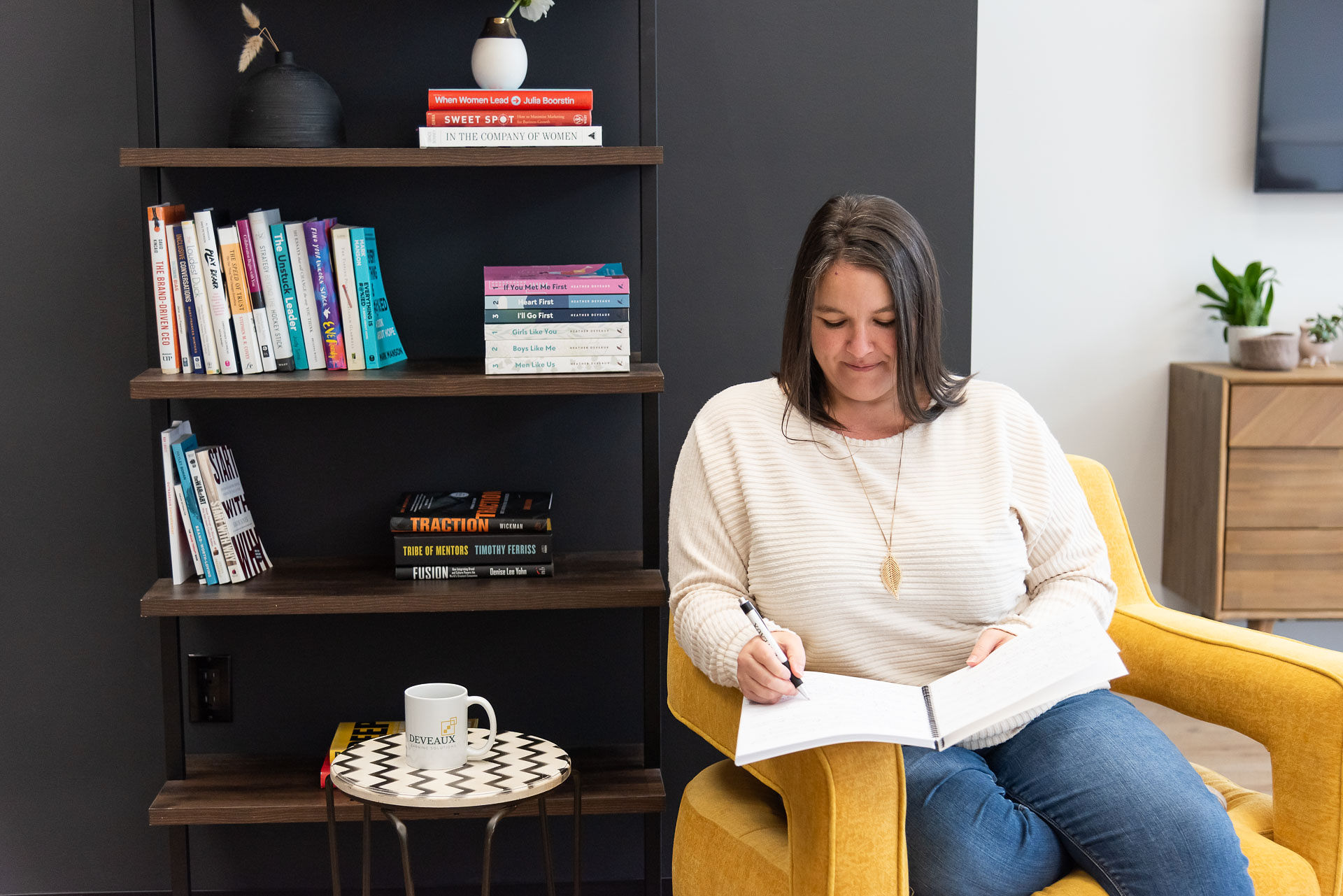 Heather Deveaux writing in a notebook, start and finish a romance novel